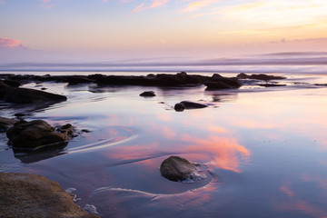 Fototapeta na wymiar Dawn and Reflections on the Beach