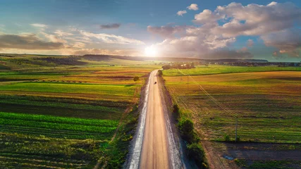 Fotobehang Aerial shot of car on the road from drone point of view © Ruslan Ivantsov