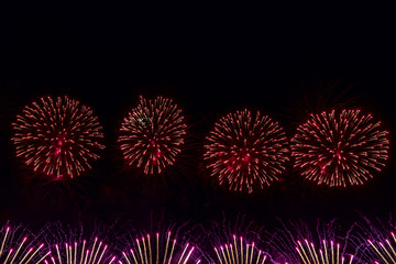 Festive fireworks on dark background.