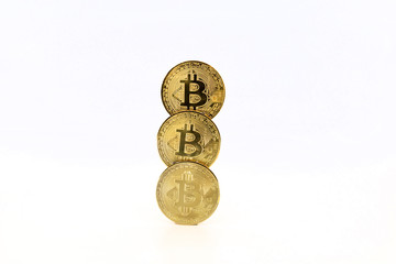 Three Bitcoin tokens stacked isolated on white background. Cryptocurrency concept with copy space.