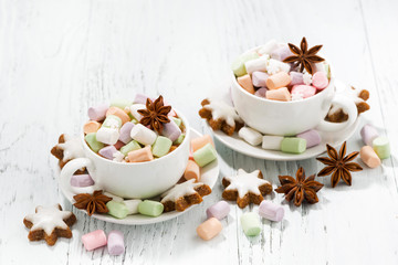 Obraz na płótnie Canvas cocoa with colorful marshmallows and Christmas cookies on white background