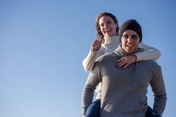 couple having fun at beach during autumn