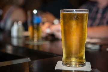 Glass of beer on a bar at a pub