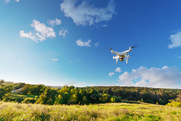Close up on white drone camera. Drone quadcopter in flight