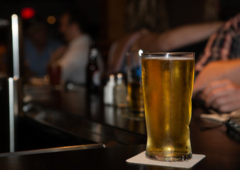 Glass of beer on a bar at a pub