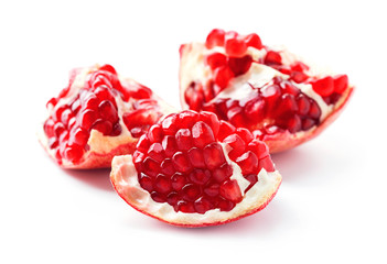 pieces of pomegranate fruit isolated on white background