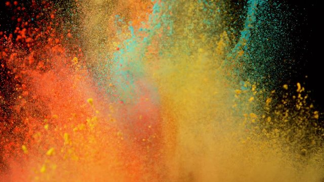 Super slowmotion shot of color powder explosions isolated on black background. Shot with high speed cinema camera at 1000fps