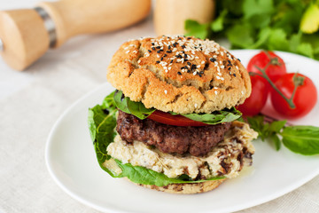 Homemade burger with gluten free bun and pesto sauce
