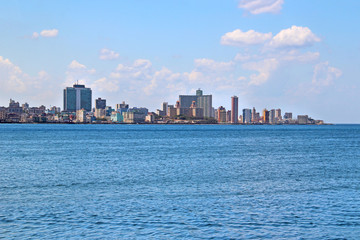 Fototapeta premium View of the panoramatic Havana in Cuba. There is blue sky and blue ocean and a lot of urbanic buildings. It is situated in carribean in America. 