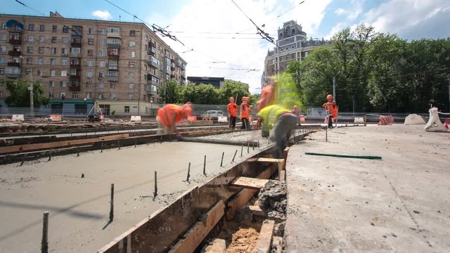 Concrete works for road maintenance construction with many workers and mixer timelapse hyperlapse