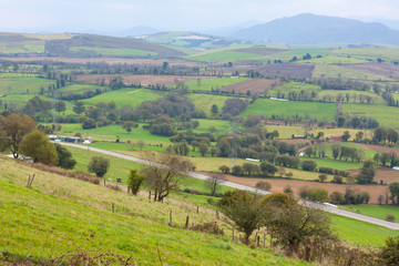 Naklejka premium Green hills with mountains in the background. Asturias, Spain