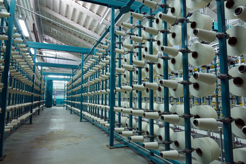 Industrial textile factory. Coils with threads in production.Fabric production .