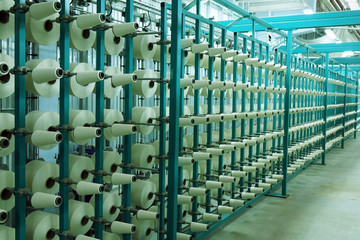 Industrial textile factory. Coils with threads in production.Fabric production .
