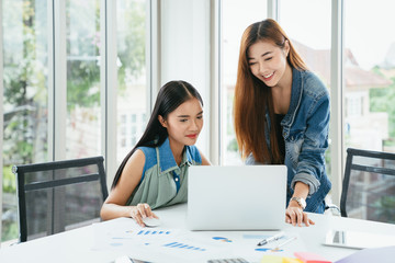 Business meeting. Two young coworker woman team making business discussion in modern office. Teamwork people concept. Casual account manager crew working new startup project on laptop. Presentation