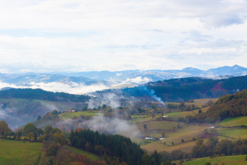Fototapeta na wymiar Green hills and mountains in the fog in Tineo, Asturias, Spain