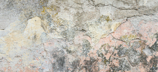Textured grunge background. Old plastered wall with a multilayer cracked coating. Grunge texture with a deep pattern on the wall