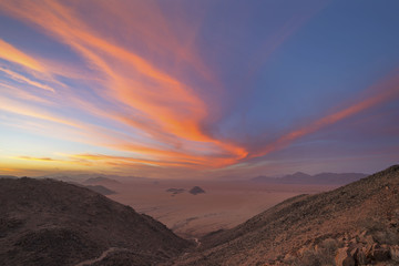 Pink colored wind swept clouds at sunset