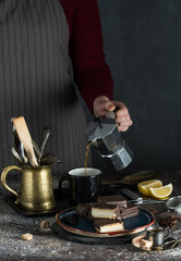 A girl is pouring mocha into a cup