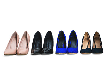Set of high heels isolated on a white background. Different colors of shoes, high heels arranged in a row. The concept of buying new shoes, lifestyle of a woman.