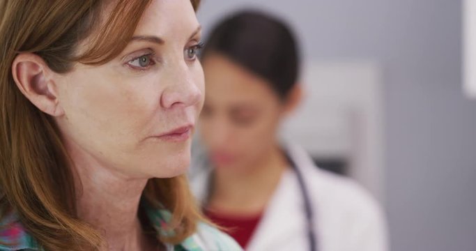 Tight shot of female patient waiting for doctor to examine her