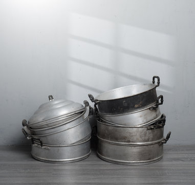Old stainless steel steamer pot against gray wall background,original style Thai cooking