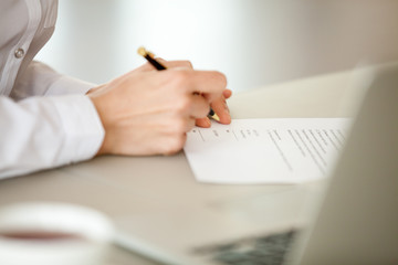 Businesswoman signing paper, female hand puts signature on business document making employment...