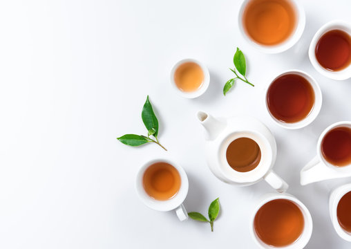 Tea concept,Teapot and cup of herbal tea with green tea leaves,top view