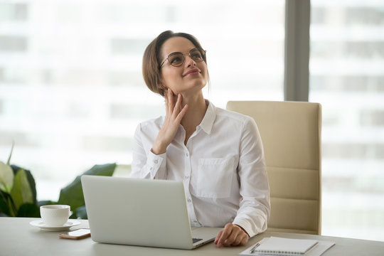 Dreamy millennial businesswoman executive thinking of future dreaming  of good career hoping for new opportunity at work, woman office employee feeling optimistic in expectation of business success