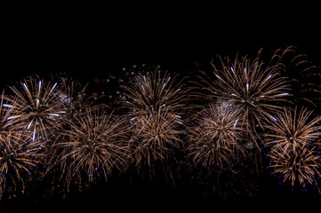 Multicolored fireworks at New Year, copy space, abstract holiday background.