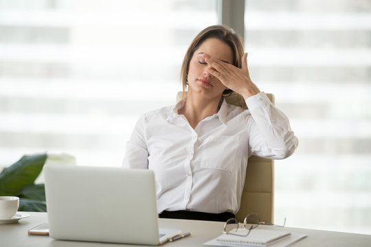 Fatigued businesswoman tired of computer work, female office worker feels dizzy from lack of sleep, headache, hormonal imbalance, eye strain tension, exhausted after long laptop use, overwork concept