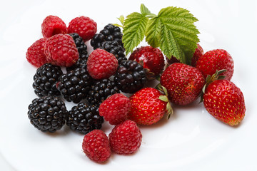 Three kinds of berries on a white