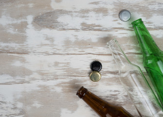 Empty beer bottles with bottle caps on table wood,after party,top view