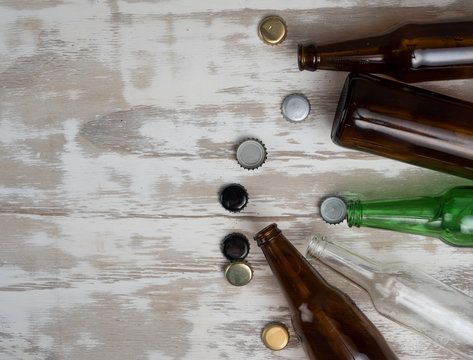 Empty beer bottles with bottle caps on table wood,after party,top view