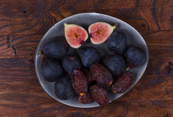 fresh figs and dates on a wooden table