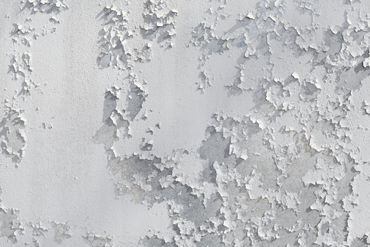 Peeling painted wall background. Old cracked grunge peeling paint texture.