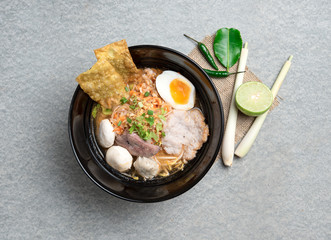 Thai spicy noodle,Thai noodle tom yum with pork,egg and meat ball on grey concrete
