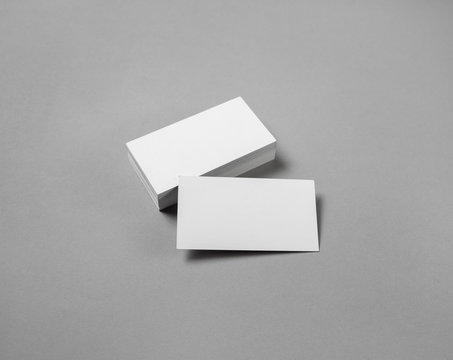 Blank white business cards on gray paper background. Template for ID with plenty of copy space.