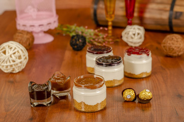Fototapeta na wymiar cheesecake in a jar with Caramel,Strawberry,Blueberry,Raspberry