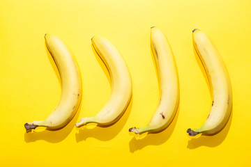 Bananas on yellow pastel background. minimal idea food concept