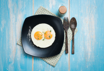 Fried eggs in a plate on a table,top view