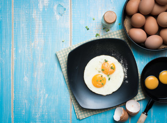 Fried eggs in a plate on a table,top view