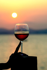 Glass with wine on the background of the sea