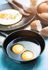 Cracked eggs in bowl and egg shells for cooking