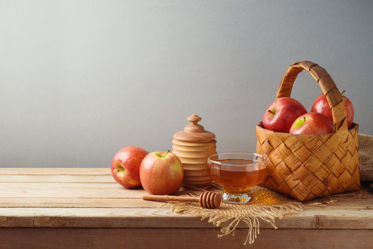 Jewish holiday Rosh Hashanah background with honey and apples in basket