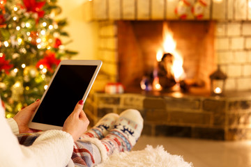 Woman sitting by fireplace
