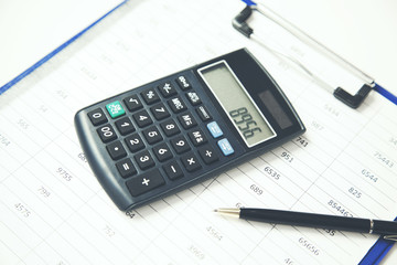 Calculator on documents on table in office