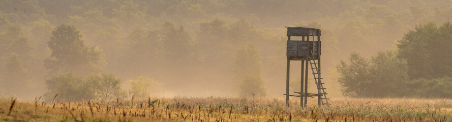 hunting tower in the valley in the morning mists