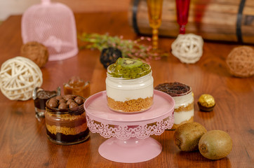 Obraz na płótnie Canvas cheesecake in a jar with tropical fruits kiwi