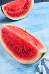 Fototapeta na wymiar cut Watermelon on blue background. Top view, flat lay.