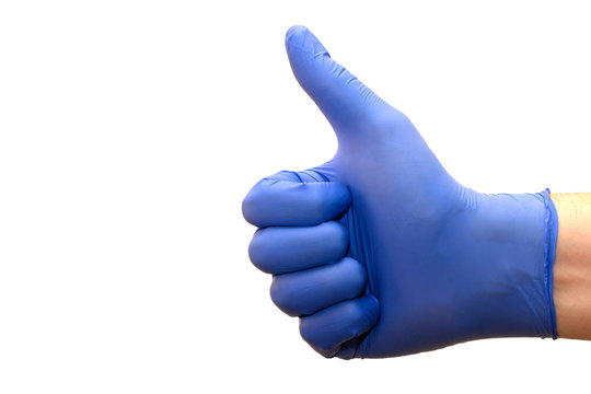 Closeup Of A Male Hand In A Blue Medical Glove Showing A Thumbs Up On A White Background.